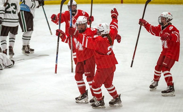 Milton's Abby Coughlin (facing) celebrates her first-period goal against Duxbury. (Patrick Donnelly/NEHJ)
