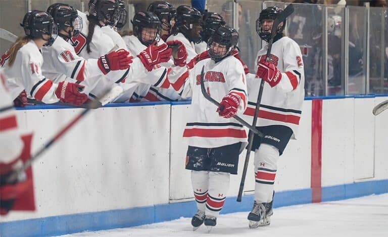 Cadence Crowley (front) celebrates her second goal against Lawrence Academy. (Patrick Donnelly/NEHJ)