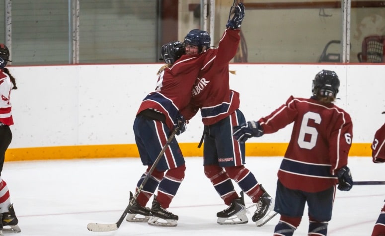 Dawson Styles (right) celebrates her game-winning goal for Tabor against Rivers. (Patrick Donnelly/NEHJ)