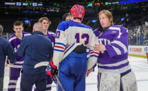 Boston Latin goalie Oliver Murphy shakes hands with Tewksbury's Cooper Robillard after Latin's win on Sunday. (Brian Kelly/NEHJ)